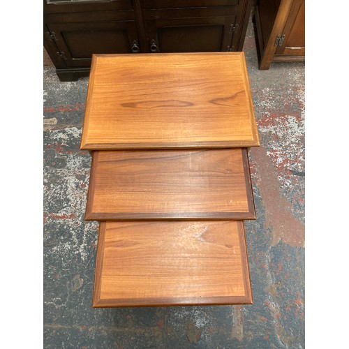 1038A - A teak nest of three tables - largest approx. 52cm high x 54cm wide x 39cm deep