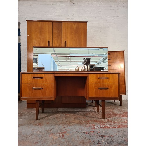 1065A - A 1960s Homeworthy teak three piece bedroom suite comprising double wardrobe, chest of six drawers a... 