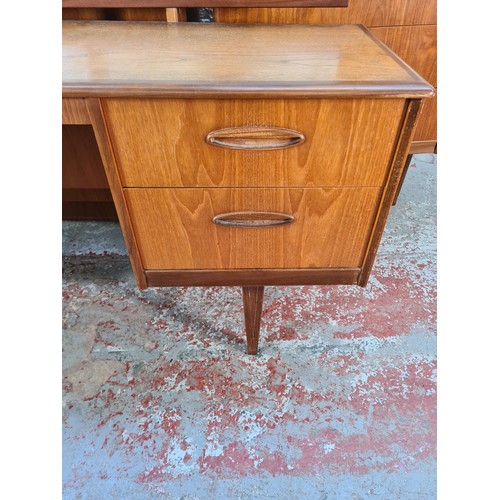 1065A - A 1960s Homeworthy teak three piece bedroom suite comprising double wardrobe, chest of six drawers a... 