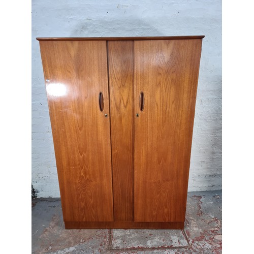 1065A - A 1960s Homeworthy teak three piece bedroom suite comprising double wardrobe, chest of six drawers a... 