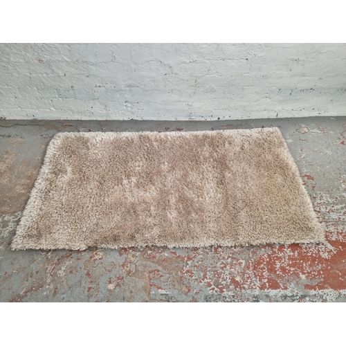 1180B - A Dunelm 'Indulgence' design champagne coloured rug - approx. 80cm x 150cm