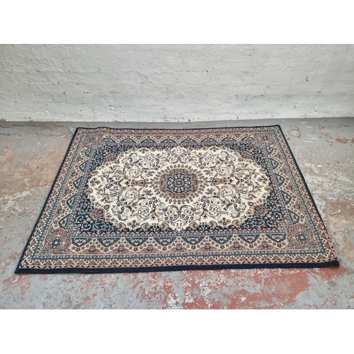 1180D - A vintage blue and cream coloured rug - approx. 166cm x 120cm