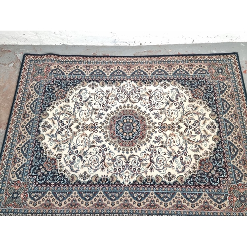 1180D - A vintage blue and cream coloured rug - approx. 166cm x 120cm