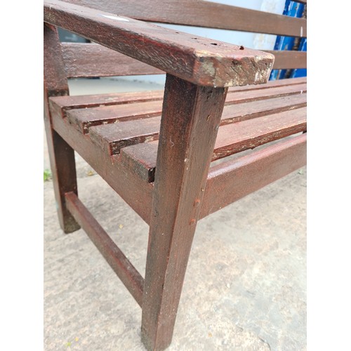 1718 - A brown painted wooden two seater garden bench - approx. 83cm high x 152cm long x 69cm deep