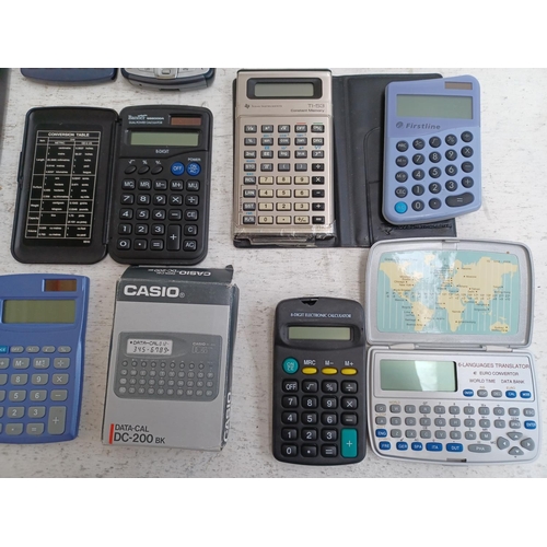 1474 - A box containing a collection of pocket calculators, pocket PCs, electronic dictionaries, translator... 