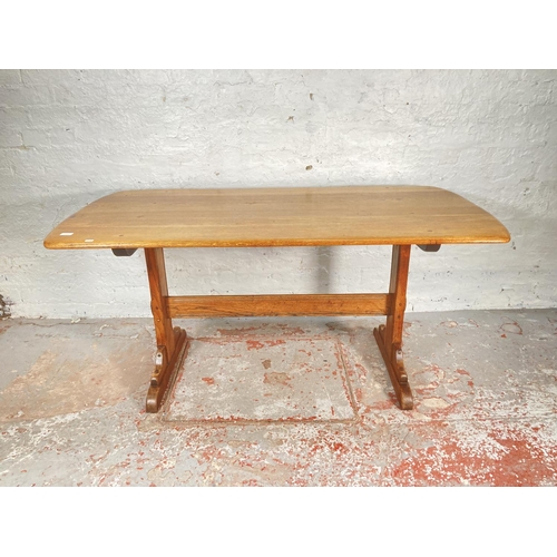 1178A - An Ercol elm and ash rectangular dining table - approx. 72cm high x 76cm wide x 153cm long