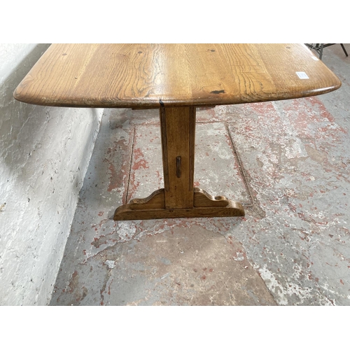 1178A - An Ercol elm and ash rectangular dining table - approx. 72cm high x 76cm wide x 153cm long