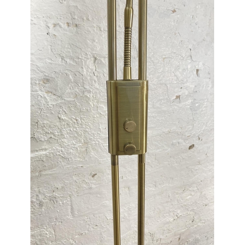 1178B - Two modern standard lamps, one brass effect - approx. 180cm high and one brushed steel effect with r... 