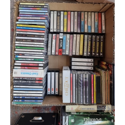 1316 - Four boxes containing a collection of CDs, DVDs, VHS videos and compact cassette tapes - see images ... 