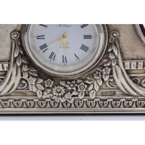 230 - An R. Carr hallmarked .925 silver fronted small mantle/bedside clock