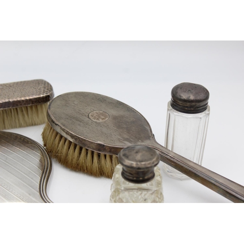 225 - Eight antique hallmarked .925 sterling silver ladies vanity items to include brushes, handled tools,... 