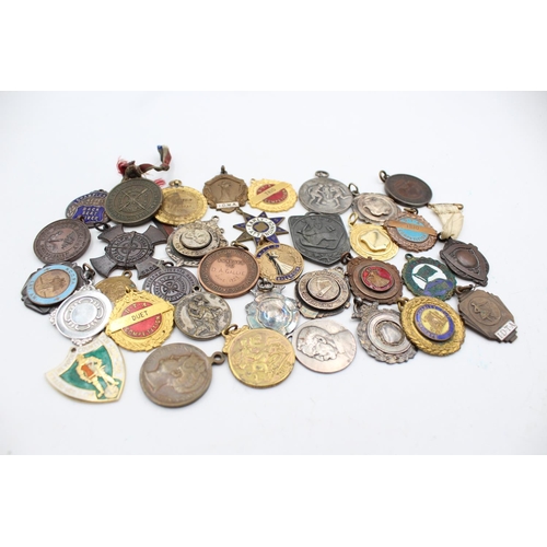 64 - A collection of antique fobs/medallions