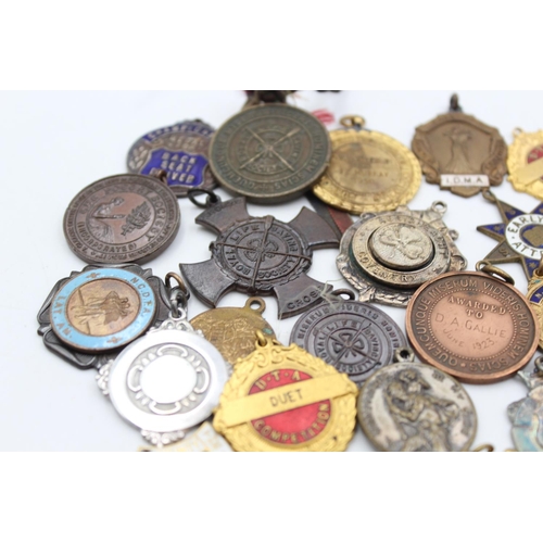 64 - A collection of antique fobs/medallions