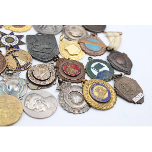 64 - A collection of antique fobs/medallions