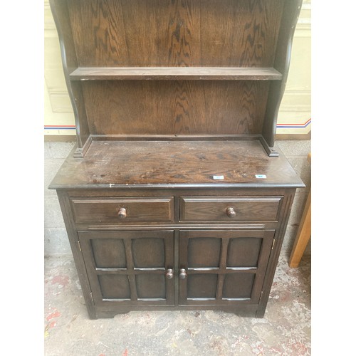 319 - An oak Dutch dresser with upper two tier plate rack, two drawers and two lower cupboard doors - appr... 