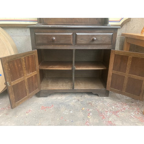 319 - An oak Dutch dresser with upper two tier plate rack, two drawers and two lower cupboard doors - appr... 