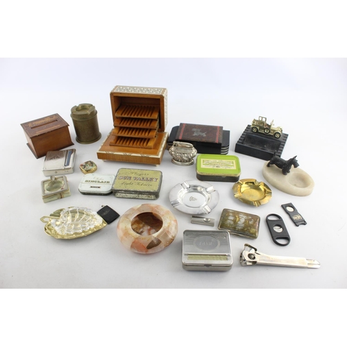 107 - A collection of assorted smoking accessories to include dispenser, tins, ashtrays etc.