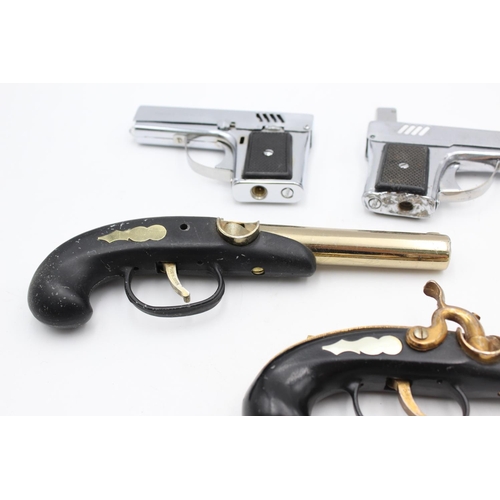 1378 - Four assorted vintage novelty gun shaped cigarette lighters