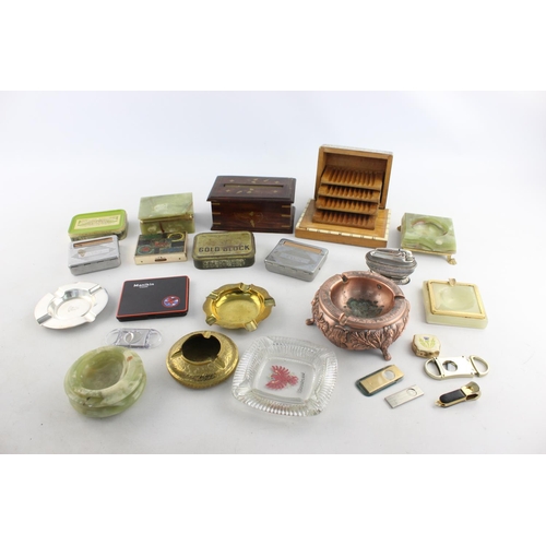 283 - A collection of assorted smoking accessories to include dispenser, tins, ashtrays etc.