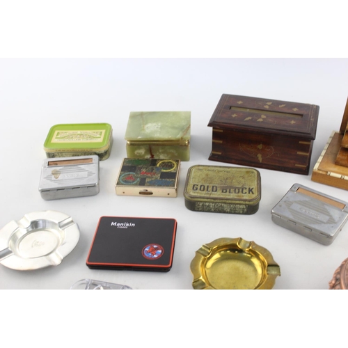 283 - A collection of assorted smoking accessories to include dispenser, tins, ashtrays etc.