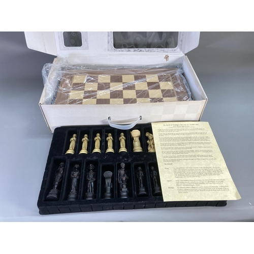 143 - A boxed Sac The Traditional Games Company Limited sculpted chess set with wooden veneer folding ches... 