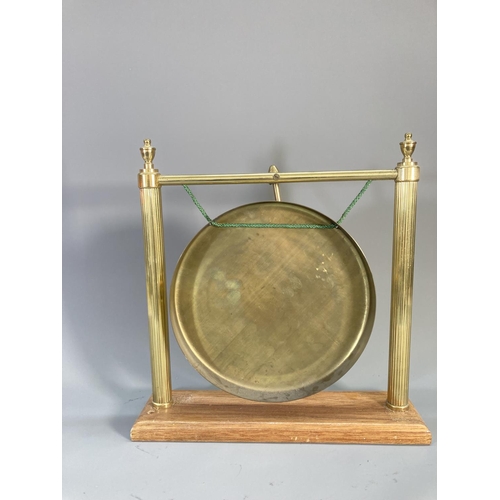 110 - A mid/late 20th century brass dinner gong with wooden stand and beater - approx. 37cm high x 36cm wi... 