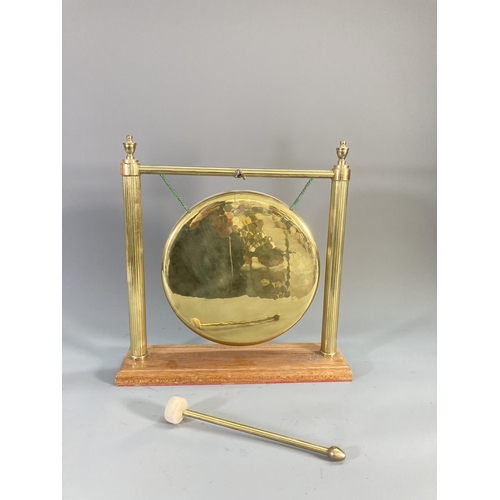 110 - A mid/late 20th century brass dinner gong with wooden stand and beater - approx. 37cm high x 36cm wi... 