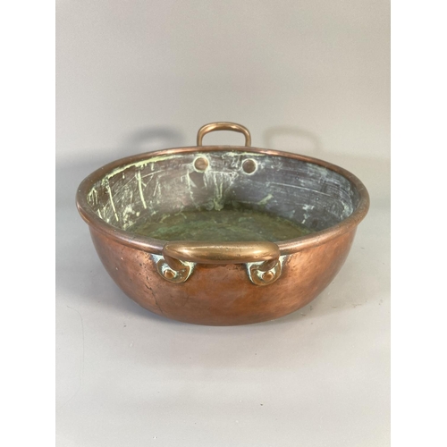 121 - A Victorian copper twin handled circular pan - approx. 32cm diameter