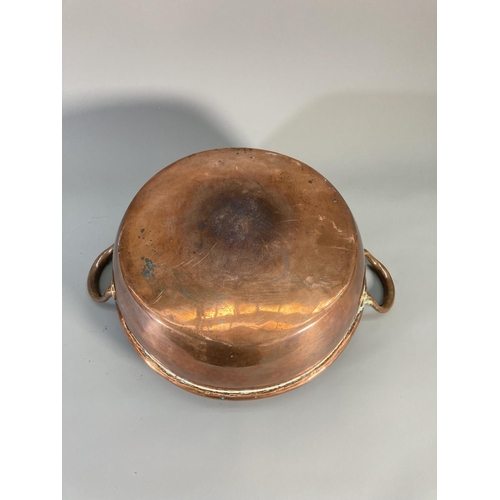 121 - A Victorian copper twin handled circular pan - approx. 32cm diameter