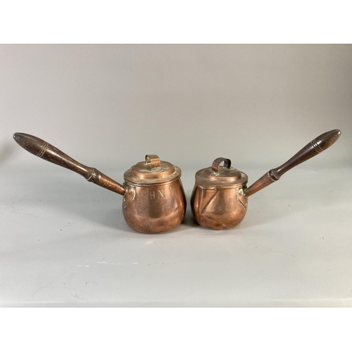 123 - Four Victorian copper measuring jugs, three monogrammed GHN with oak handles and one I. Warner & Son... 