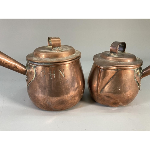 123 - Four Victorian copper measuring jugs, three monogrammed GHN with oak handles and one I. Warner & Son... 