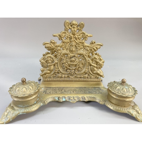 130 - A mid 20th century brass ink stand with cherub design - approx. 20cm high x 30cm wide x 20cm deep