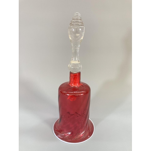 69 - Three late 19th century cranberry glass bells - largest approx. 29cm high