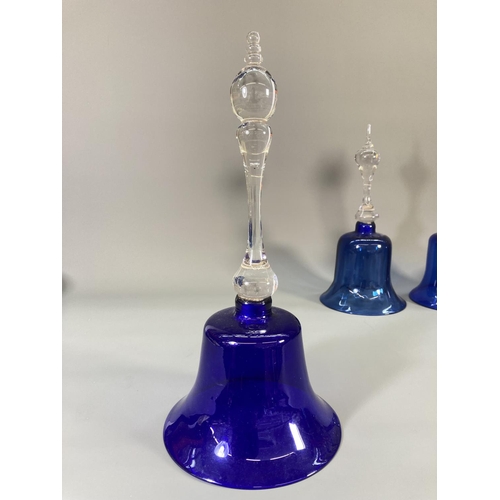 72 - Four late 19th century blue glass bells - largest approx. 31cm high and two blue glass circular bowl... 