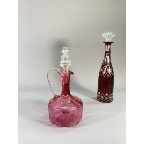 73 - Four coloured glass decanters to include two late 19th century cranberry glass etc.