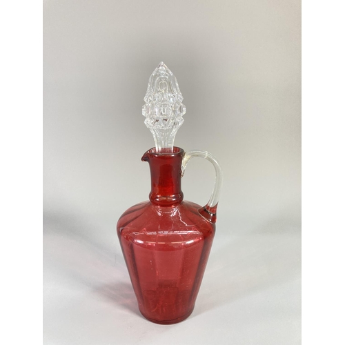 73 - Four coloured glass decanters to include two late 19th century cranberry glass etc.