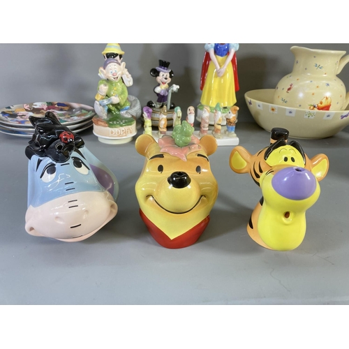 84 - A collection of Disney ceramics and collectables to include Winnie the Pooh jug and bowl, Clover Sno... 