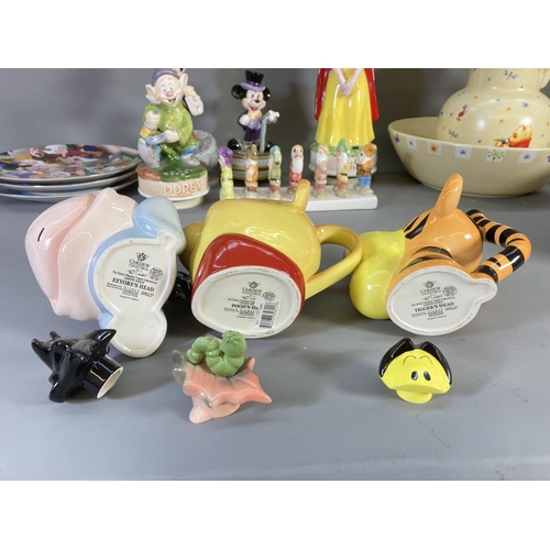 84 - A collection of Disney ceramics and collectables to include Winnie the Pooh jug and bowl, Clover Sno... 