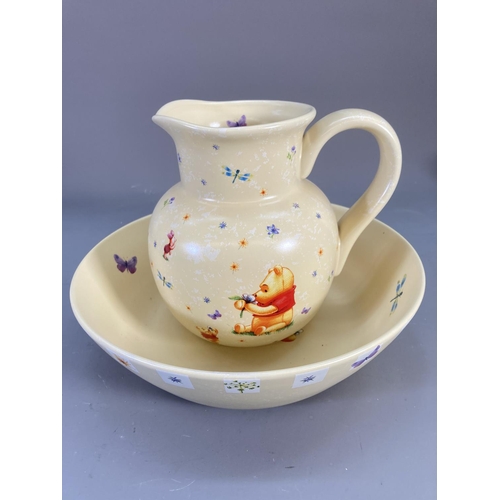 84 - A collection of Disney ceramics and collectables to include Winnie the Pooh jug and bowl, Clover Sno... 