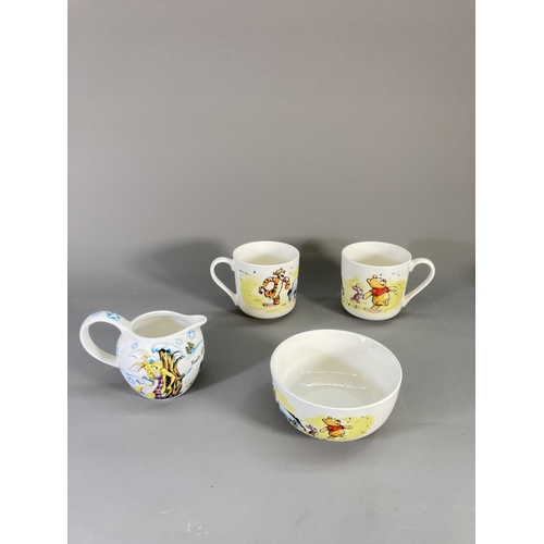 89 - A collection of Disney Winnie the Pooh ceramics to include boxed mug and coaster, bowl, plates etc.