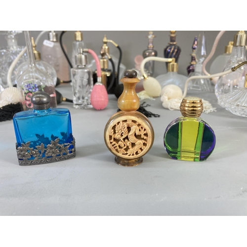 91 - A collection of studio glass atomisers and scent bottles to include Royal Welsh Crystal, Venetian gl... 