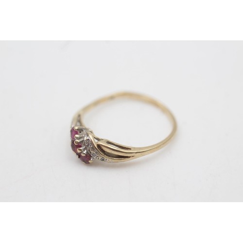 2067 - A 9ct gold ruby and diamond twist band ring, size P - approx. gross weight 1.5 grams