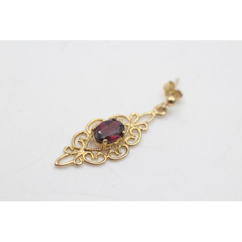 2069 - A pair of 9ct gold garnet solitaire openwork drop earrings - approx. gross weight 2.2 grams