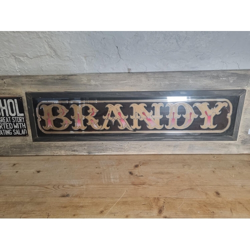 287 - A vintage glass brandy sign with reclaimed wooden frame and red painted servants bell - approx. 122c... 