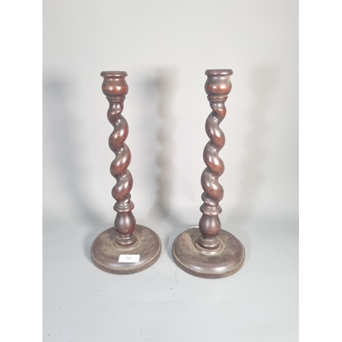 292 - A pair of mid 20th century oak barley twist candle sticks - approx. 36cm high