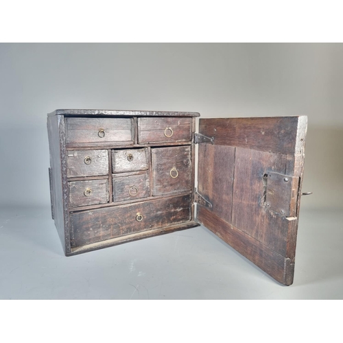 302 - A 17th century oak spice cabinet with fitted interior and geometric moulded door - approx. 32cm high... 