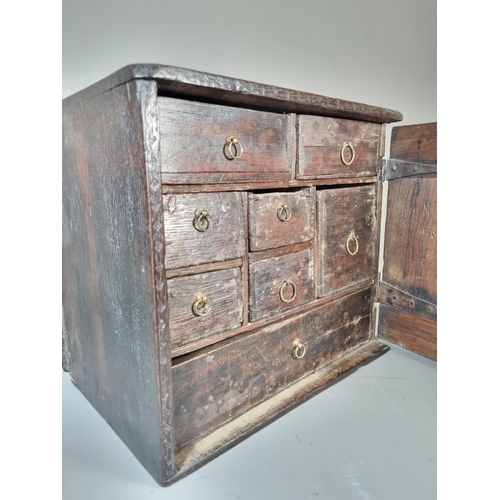 302 - A 17th century oak spice cabinet with fitted interior and geometric moulded door - approx. 32cm high... 