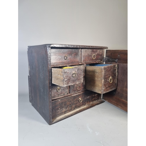 302 - A 17th century oak spice cabinet with fitted interior and geometric moulded door - approx. 32cm high... 