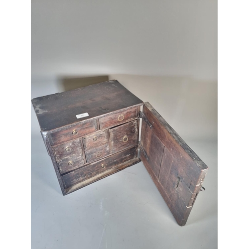 302 - A 17th century oak spice cabinet with fitted interior and geometric moulded door - approx. 32cm high... 