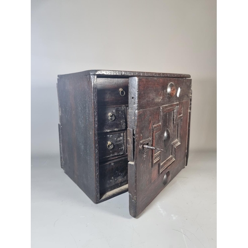 302 - A 17th century oak spice cabinet with fitted interior and geometric moulded door - approx. 32cm high... 